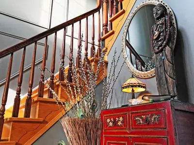 a staircase with a mirror and a red dresser at Butler Creek House in Niagara on the Lake