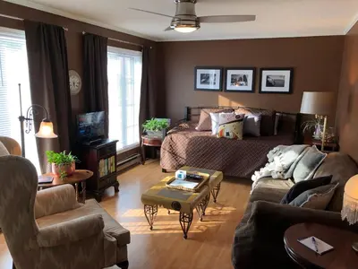 a living room with a bed and a couch at Butler Creek House in Niagara on the Lake