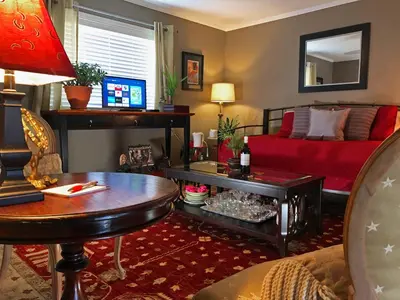 a living room with a couch and a table at Butler Creek House in Niagara on the Lake