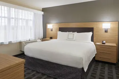 a large white bed in a hotel room at TownePlace Suites by Marriott Oshawa in Oshawa