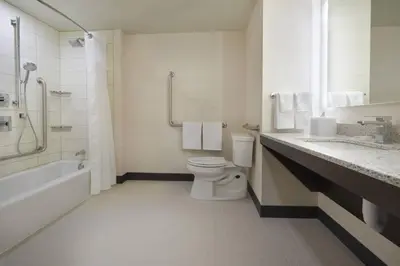 a bathroom with a toilet and a sink and a shower at TownePlace Suites by Marriott Oshawa in Oshawa