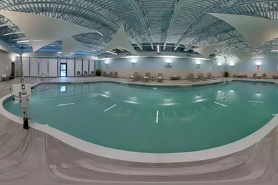 a swimming pool in a building with a ceiling at TownePlace Suites by Marriott Oshawa in Oshawa