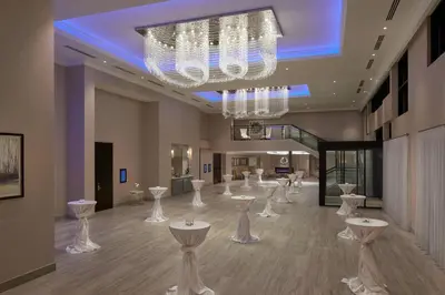 a large room with white tables and chandeliers at TownePlace Suites by Marriott Oshawa in Oshawa