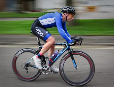 a man riding a bike down a street at Old Ivy Walk in Niagara on the Lake