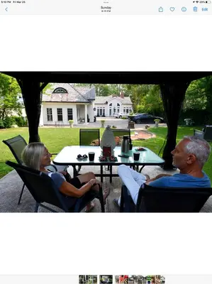 a man and woman sitting at a table in chairs at Old Ivy Walk in Niagara on the Lake