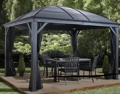a gazebo with a table and chairs under it at Old Ivy Walk in Niagara on the Lake