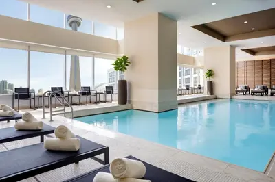 a swimming pool with blue water in a building at The Ritz-Carlton, Toronto in Toronto