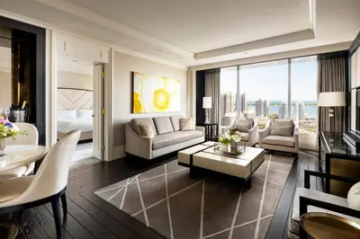 a living room with a bed and a room with a table at The Ritz-Carlton, Toronto in Toronto