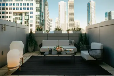 a patio with a couch and a table on a rooftop at The Ritz-Carlton, Toronto in Toronto