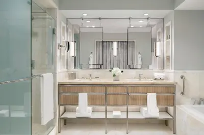 a bathroom with a sink and a shower and a mirror at The Ritz-Carlton, Toronto in Toronto