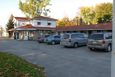 a group of cars parked in a parking lot at Kings Inn Orillia in Orillia