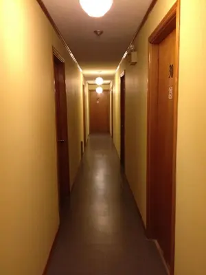 a hallway of an office building with a long corridor at Cedar Springs Motel in Acton