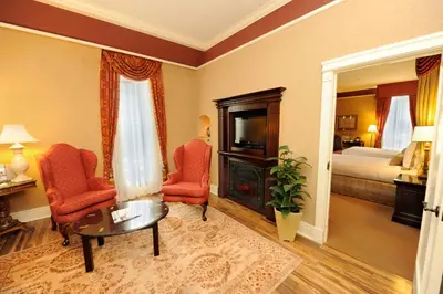 a room with two chairs and a table and a bed at Old Mill Toronto Hotel in Toronto