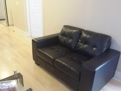a black leather couch sitting in a living room at BEST LOCATION/SPECTACULAR VIEW 2 BEDROOMS FURNISHED CONDO S/L RENT in Mississauga