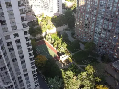 an urban park in a city with tall buildings at BEST LOCATION/SPECTACULAR VIEW 2 BEDROOMS FURNISHED CONDO S/L RENT in Mississauga