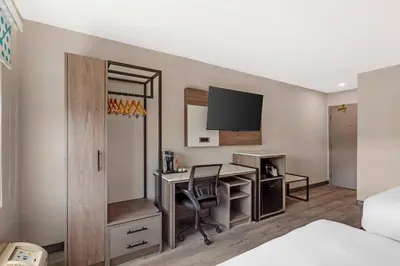 a hotel room with a desk and a tv at Comfort Inn in Bracebridge