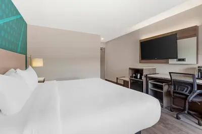 a hotel room with a large bed and a desk at Comfort Inn in Bracebridge