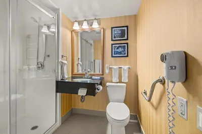 a bathroom with a toilet and a sink and a shower at Comfort Inn in Saint Thomas