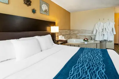 a hotel room with a bed and a bath tub at Comfort Inn in Saint Thomas