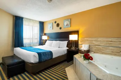 a hotel room with a bed and a bath tub at Comfort Inn in Saint Thomas
