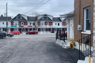 an empty street in a town with houses and cars at Lucien Motel in Whitby