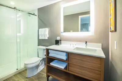 a bathroom with a sink and a toilet and a shower at Comfort Inn & Suites in Ingersoll
