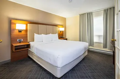 a large white bed in a hotel room at Comfort Inn & Suites in Ingersoll