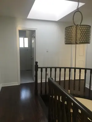 a hallway with a staircase and a ceiling light at Home Base in Markham