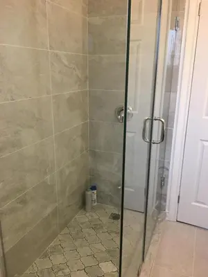 a shower with a glass door in a bathroom at Home Base in Markham