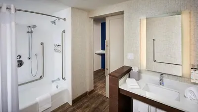 a bathroom with a tub and a sink and a shower at Holiday Inn Express Niagara-On-The-Lake by IHG in Niagara on the Lake