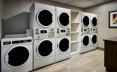 four washers and dryers in a laundry room at Holiday Inn Express Niagara-On-The-Lake by IHG in Niagara on the Lake