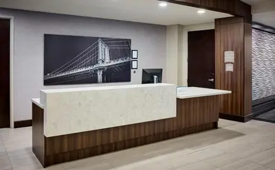 a lobby with a picture of a bridge on the wall at Staybridge Suites Niagara-On-The-Lake by IHG in Niagara on the Lake