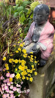 a statue of a little girl sitting next to flowers at Globetrotters B&B in Niagara on the Lake