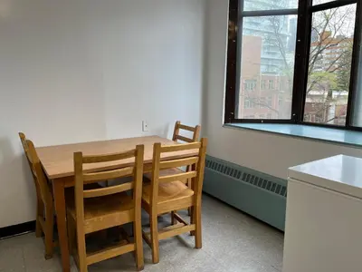 a kitchen with a table and chairs and a window at Neill Wycik Hostel in Toronto