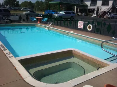 a large swimming pool with blue water in it at Rainbow Motor Inn - Fallsview in Niagara Falls
