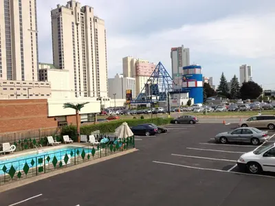 a parking lot with a roller coaster in a city at Rainbow Motor Inn - Fallsview in Niagara Falls