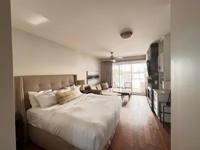 a bedroom with a large bed and a living room at Touchstone Resort in Bracebridge
