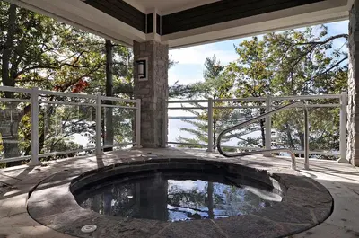 a swimming pool on a screened in porch with a pool at Touchstone Resort in Bracebridge