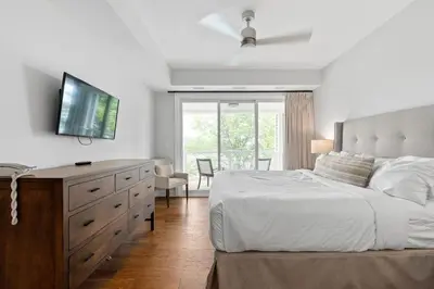 a bedroom with a bed and a dresser with a television at Touchstone Resort in Bracebridge