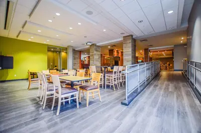 a dining area with tables and chairs in a restaurant at United College in Waterloo
