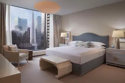 a hotel room with a bed and a large window at Hilton Toronto in Toronto