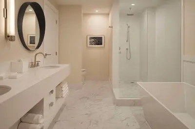 a white bathroom with a sink and a shower at Hilton Toronto in Toronto