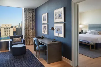 a hotel room with a bed and a desk with a chair at Hilton Toronto in Toronto