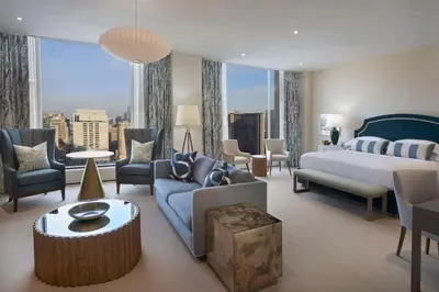 a bedroom with a king sized bed and a living room at Hilton Toronto in Toronto