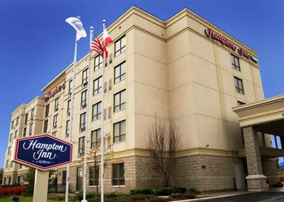 a building with a sign in front of it at Hampton Inn Toronto-Mississauga West in Mississauga