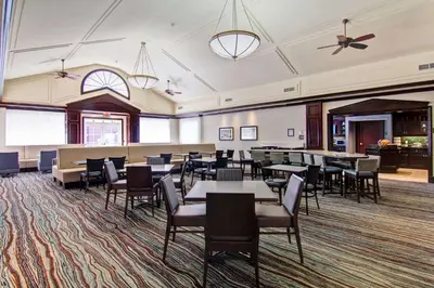 a dining room with tables and chairs and a ceiling at Homewood Suites by Hilton Toronto Mississauga in Mississauga