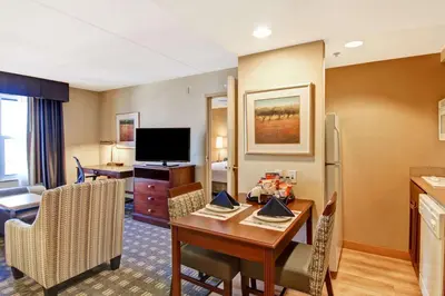 a living room with a kitchen and a dining room at Homewood Suites by Hilton Toronto Mississauga in Mississauga