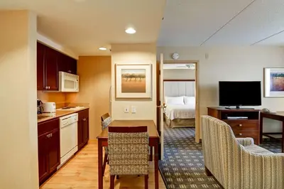 a hotel room with a kitchen and a bedroom at Homewood Suites by Hilton Toronto Mississauga in Mississauga