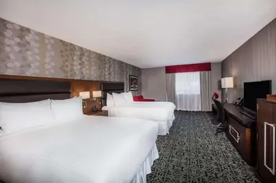 a hotel room with two beds and a television at Ramada by Wyndham Jackson's Point in Georgina