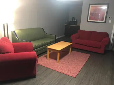 a living room with two chairs and a table at Ramada by Wyndham Jackson's Point in Georgina